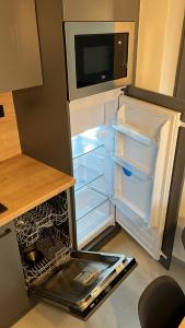 an empty refrigerator with its door open in a kitchen at The Houses - Chata u sjezdovky 1 in Velké Meziříčí