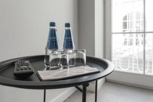 a table with three wine glasses and a remote control at Pałac Widokowy in Toruń