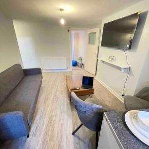 a living room with a couch and a table at London Apartment - Near Kings Cross St Pancreas! in London