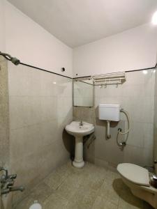 y baño con lavabo, aseo y espejo. en HOTEL PANETAR PALACE, en Ahmedabad