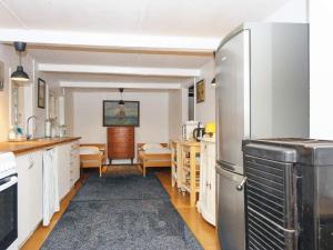 een keuken met witte kasten en een koelkast bij 5 person holiday home in Skanderborg in Skanderborg