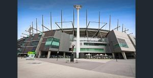 a large building in front of a stadium at Knightsbridge Apartments in Melbourne +24 photos