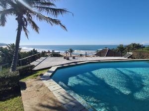 a swimming pool with a view of the ocean at THE ARK in Zinkwazi Beach in Zinkwazi Beach
