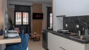 a kitchen with a sink and a counter top at ORIENTE SUITE APARTMENT in Kalabaka