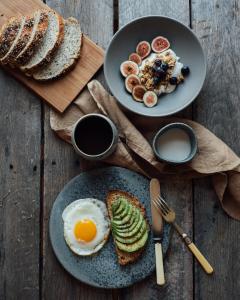 two plates of breakfast foods on a wooden table at The Yarn in Horgen