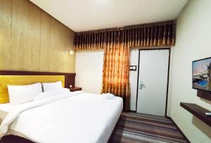 Postel nebo postele na pokoji v ubytování Hotel Syariah GS Lampung Culture, Bandar Lampung