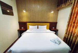 Postel nebo postele na pokoji v ubytování Hotel Syariah GS Lampung Culture, Bandar Lampung