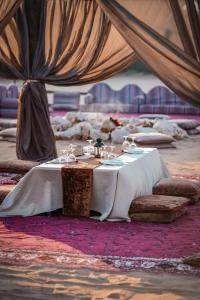 a table with wine glasses on it in a tent at Nujoum Overnight Camp with Signature Desert Safari in Dubai