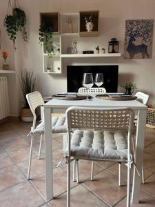 a white table and chairs in a living room at Casa Giulietta Torno with lake view terrace in Torno