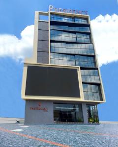 a tall building with a sign on top of it at PRESIDENCY AIRPORT HOTEL in Cochin