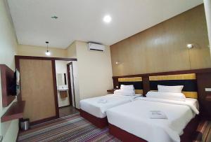 Postel nebo postele na pokoji v ubytování Hotel Syariah GS Lampung Culture, Bandar Lampung