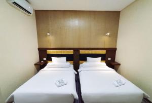 Postel nebo postele na pokoji v ubytování Hotel Syariah GS Lampung Culture, Bandar Lampung