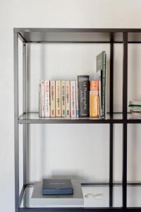 a book shelf with books and a laptop on it at L'appartement Casquette in Liège