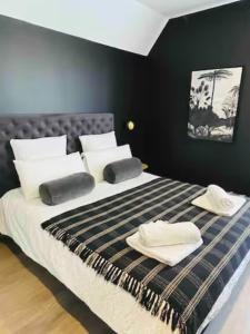 um quarto com uma cama grande e almofadas brancas em Le Blue Moon - 50m centre historique - parking privatif em Sarlat-la-Canéda