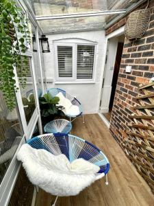 a patio with two chairs and a table on a balcony at Terrace House - Charming home near town and train station in Nantwich