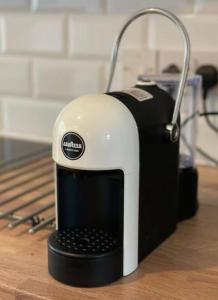 a black and white appliance sitting on a table at Terrace House - Charming home near town and train station in Nantwich