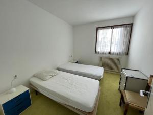 En eller flere senge i et værelse på Appartement avec terrasse vue sur piste à Praloup
