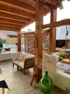 un patio cubierto con sofá y mesa en ittiturismo S.Croce, en Teulada