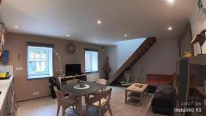a kitchen and living room with a table and chairs at Gîte La Chevrière in Sougné-Remouchamps