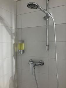 y baño con ducha con cabezal de ducha. en RESIDENZA GIOVANNI, en Contone