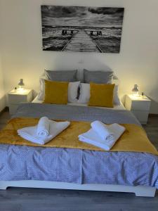 a bedroom with a bed with two towels on it at RESIDENZA GIOVANNI in Contone
