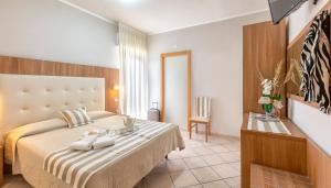 Habitación de hotel con cama y mesa en Hotel Roland, en Riccione