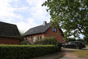 a house with a car parked in front of it at Ferienhaus Kappeln in Rabenkirchen-Faulück
