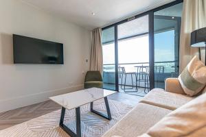 a living room with a couch and a flat screen tv at Luxurious 1 Bed - RIVER VIEW in Liverpool