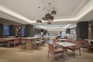 a dining room with tables and chairs in a restaurant at Four Points by Sheraton Suzhou, Wuzhong in Suzhou