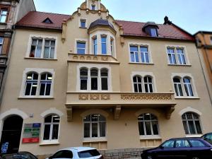 a building with cars parked in front of it at BoleslaviaApartments - Apartament Simon 2, Center, air conditioning in Bolesławiec