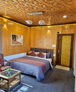 a bedroom with a bed and a couch and a table at Gulmarg Woods By Stay Pattern in Gulmarg