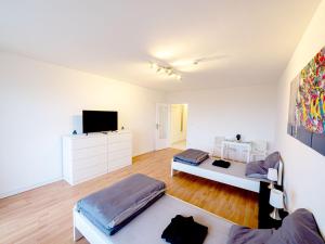 a living room with two beds and a flat screen tv at Nice Appartement in Trappenkamp in Trappenkamp