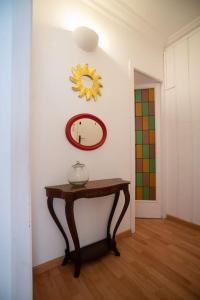 a room with a table and a clock on a wall at Stunning Designer 2 Bed Apt in Glorious Gràcia in Barcelona
