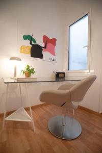 a white desk with a chair in a room at Stunning Designer 2 Bed Apt in Glorious Gràcia in Barcelona
