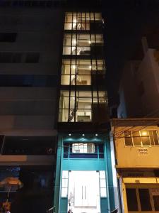 a tall building with a balcony on top of it at 8 minutes walking to Nguyen Hue, Fast Wifi, check-in 24/7 in Ho Chi Minh City +24 photos