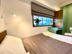 a small bedroom with a bed and a window at 8 minutes walking to Nguyen Hue, Fast Wifi, check-in 24/7 in Ho Chi Minh City