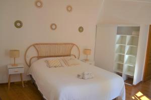 a bedroom with a white bed with two towels on it at Mas Sant Jordi in Alénya