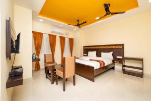 a bedroom with a bed and a flat screen tv at Hotel Rifaya in Porto Novo +45 photos