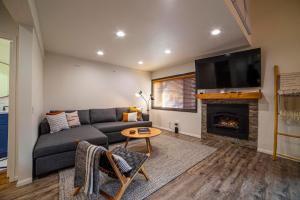 a living room with a couch and a fireplace at #456 - Alpine High Retreat - Ski-In, Walk to Canyon Lodge in Mammoth Lakes