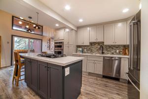 a large kitchen with white cabinets and a counter top at #456 - Alpine High Retreat - Ski-In, Walk to Canyon Lodge in Mammoth Lakes