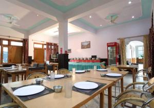 a dining room with wooden tables and chairs at Sapphire Inn in Bhīm Tāl