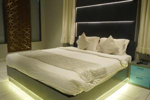 a bedroom with a large bed with white sheets and pillows at NT Hotels and Resorts Akridha in Puducherry