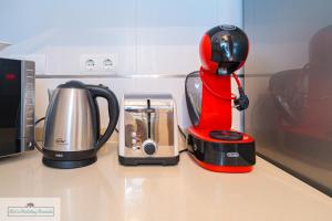 a red blender sitting on a counter next to a coffee maker at Luxury 2 Bed 2 Bath Apartment with pool in El Campello