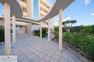an external view of a building with columns and plants at Luxury 2 Bed 2 Bath Apartment with pool in El Campello