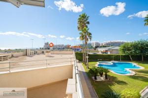 a view from the balcony of a resort with a swimming pool at Luxury 2 Bed 2 Bath Apartment with pool in El Campello