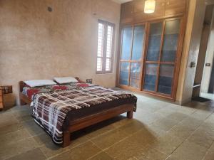 a bedroom with a bed in a room at Serene meadows villa in Bangalore