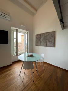 a dining room with a glass table and a chair at B&B Aganita in Ancona