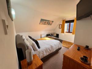 a bedroom with a bed and a television in it at 44 Trevithick view in Saint Erth