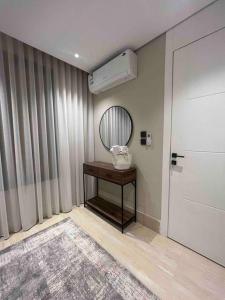a room with a table with a mirror and a air conditioner at Modern 3 Bedroom Flat in Riyadh