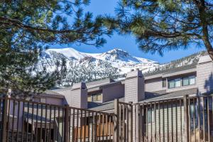 a building with snow covered mountains in the background at #572 Walk to Eagle Lodge with Spa & Pool in Mammoth Lakes